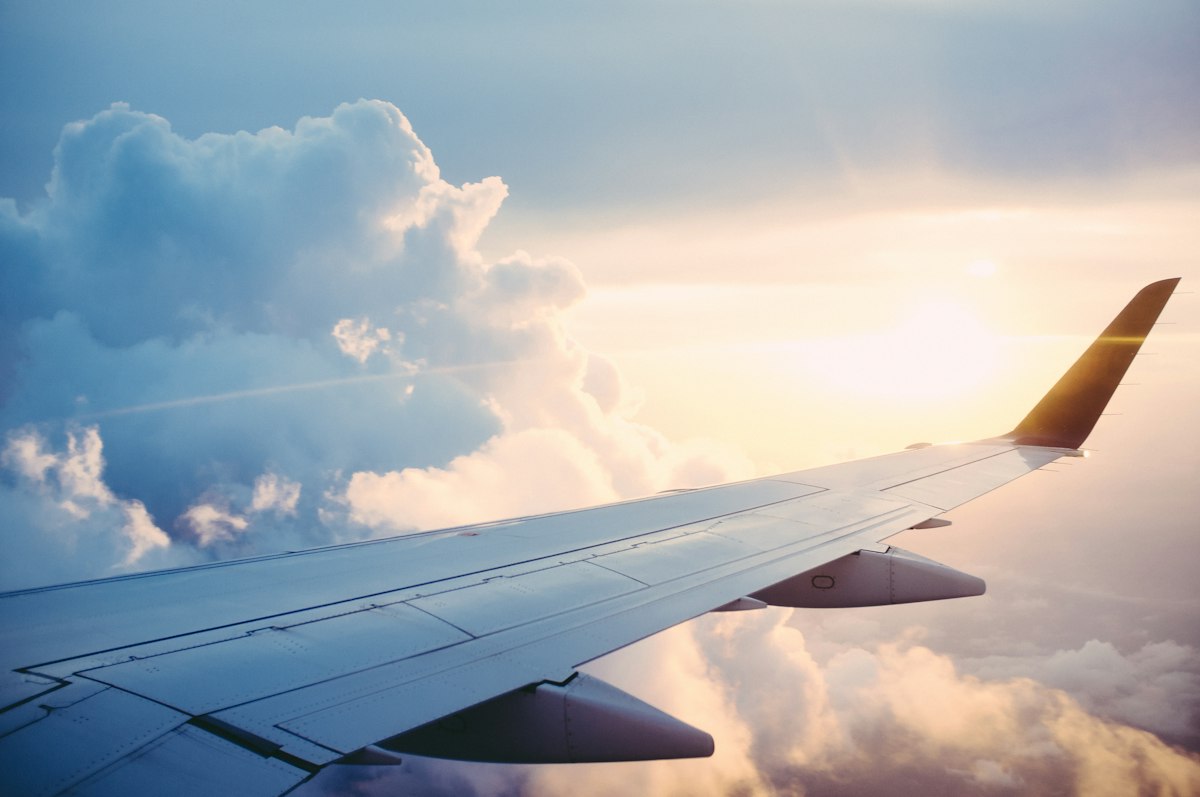 Aircraft wing flying above the clouds
