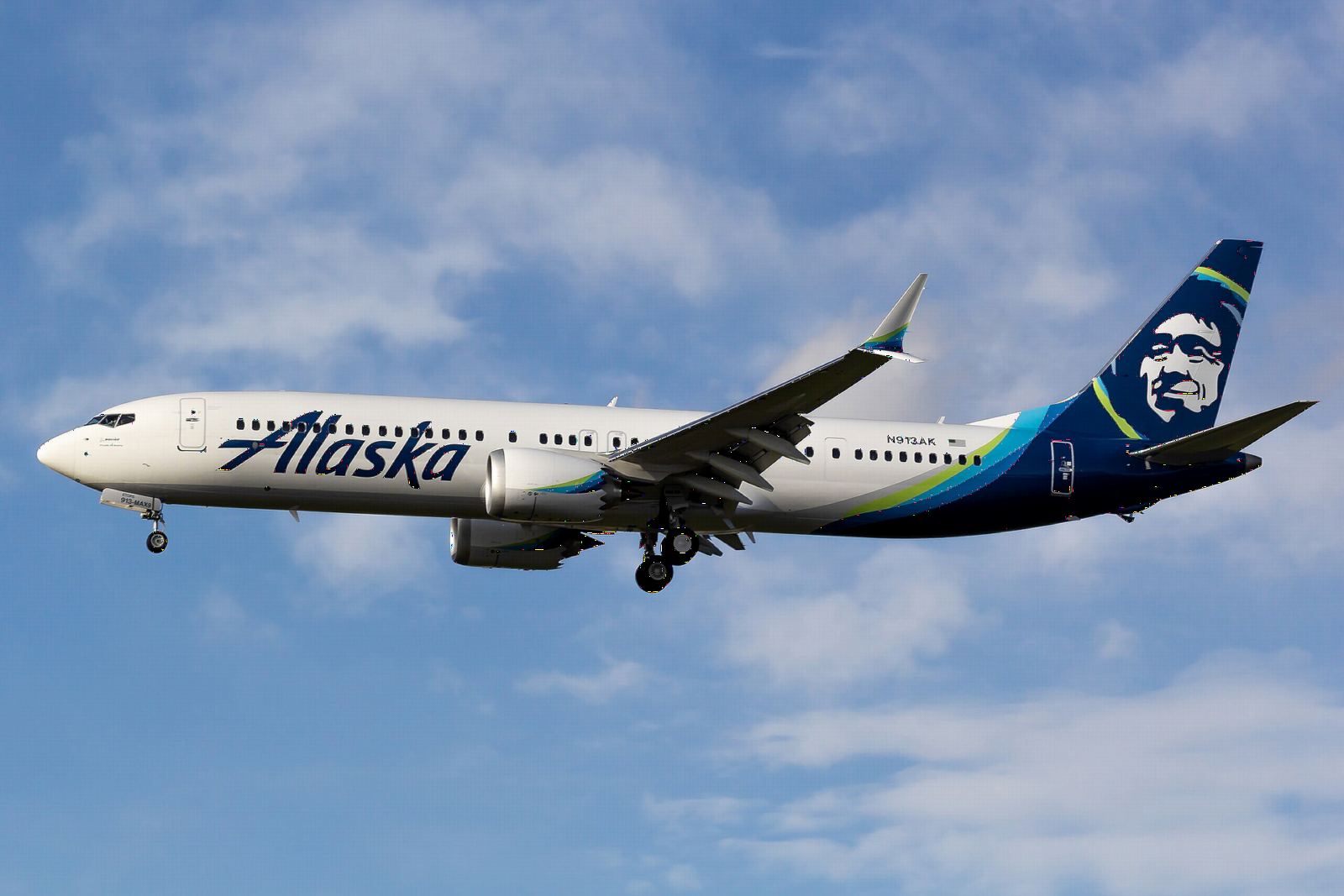 Alaska Airlines Boeing 737 MAX 9 climbing through scattered clouds
