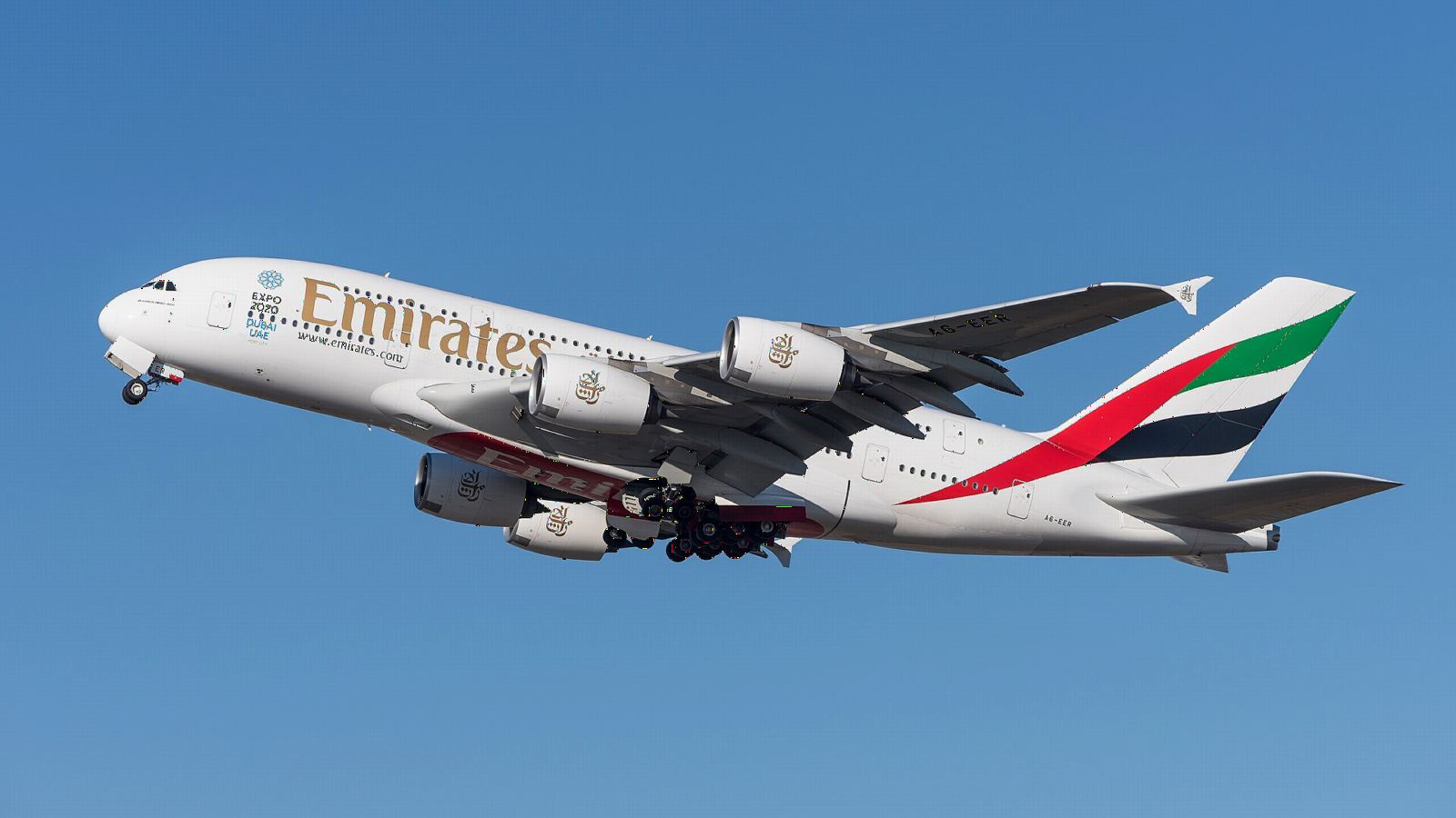 Emirates Airbus A380 climbing after take-off with its red, green and black tail
