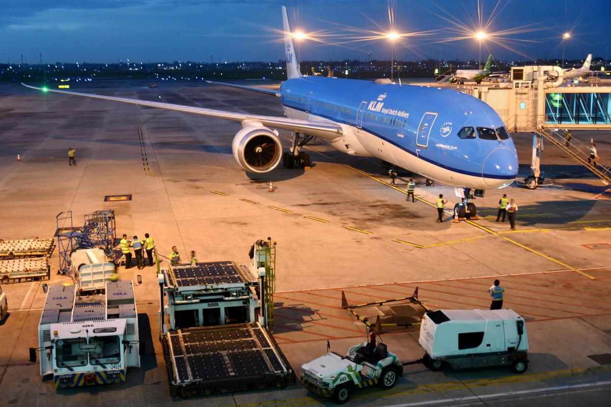 KLM Boeing 787 parked at the gate at dusk