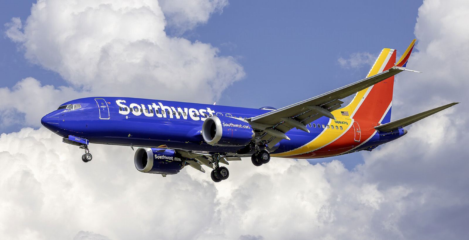 Southwest Airlines Boeing 737 MAX 8 on approach in front of white clouds